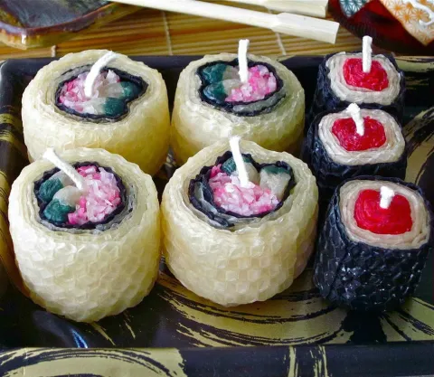 Picture of a candle made from beeswax, shaped into sushi rolls.