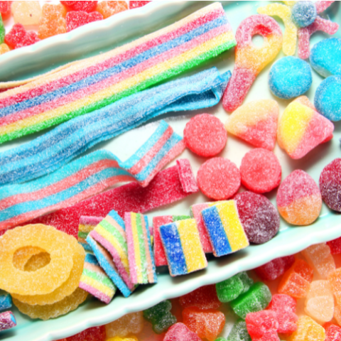 a photograph of variouse bright color candies. There are shapes of round, square, rectangles, and ropes. 