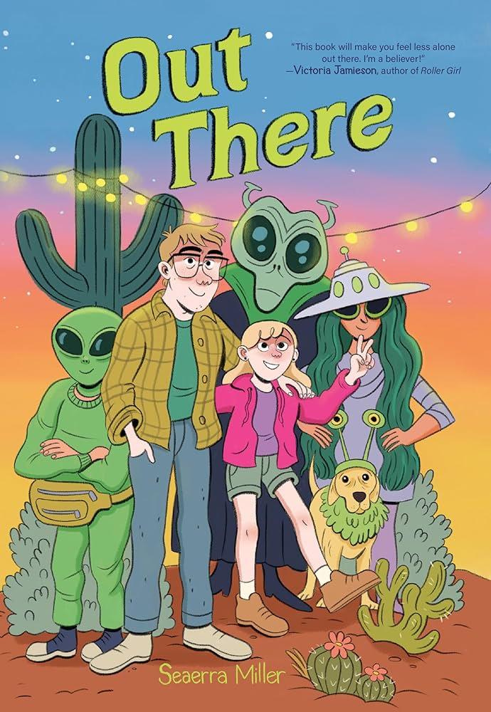 A family in the desert with people dressed up as space aliens. Everyone is happy. 